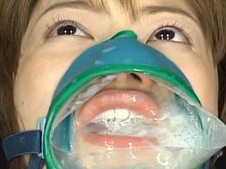Ruri Anno is fastened down and takes cumshots into this cum facial mask over her mouth and nose.